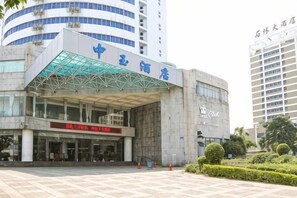 A modern building with a glass entrance and signage indicating it is a hotel. - Zhongyu Hotel (Beihai)