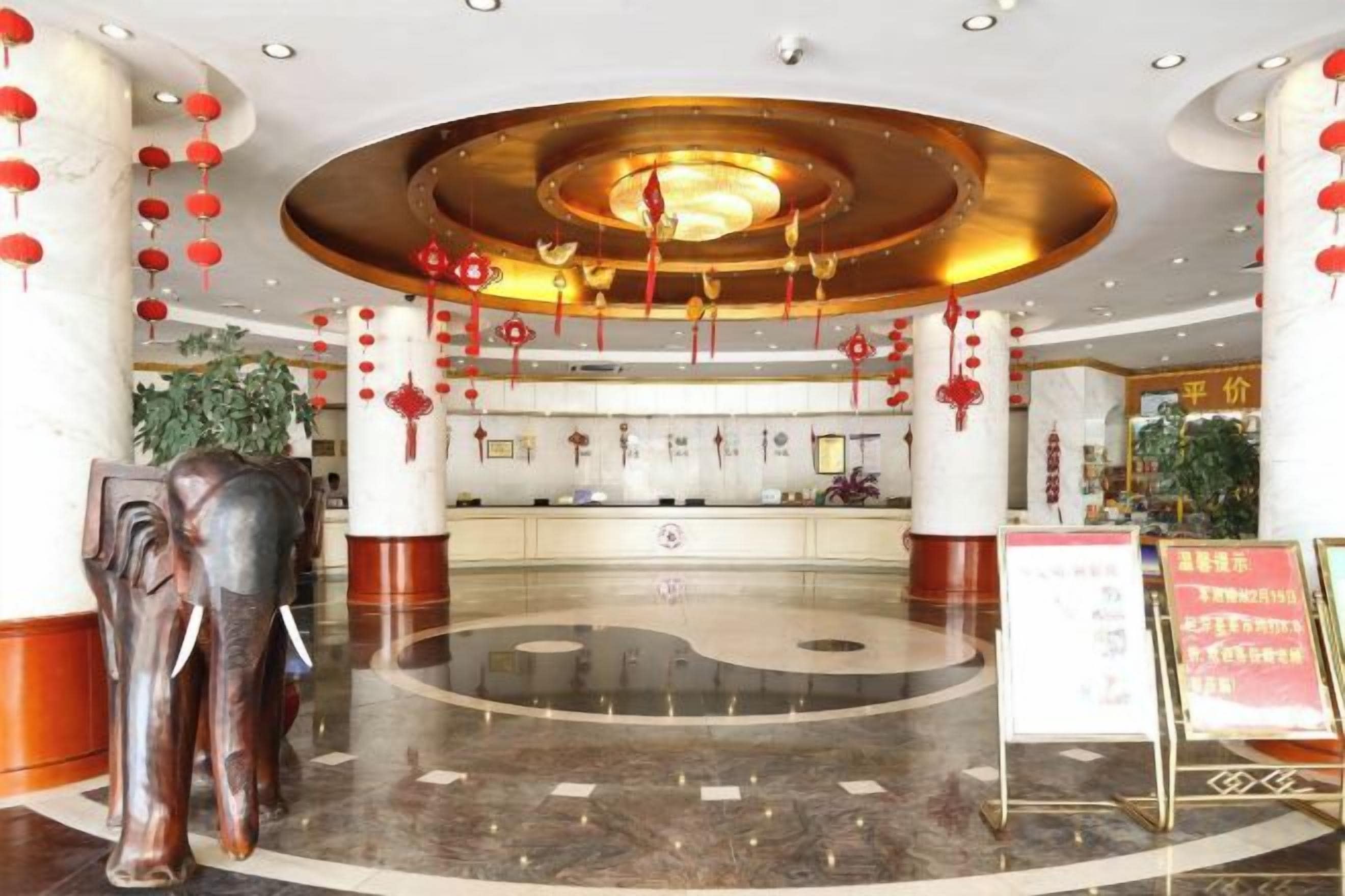 A lobby with a central circular area, columns, and a reception desk.