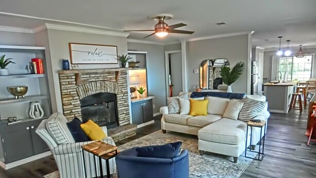 A living room with a fireplace, a sofa, a chair, and a coffee table.