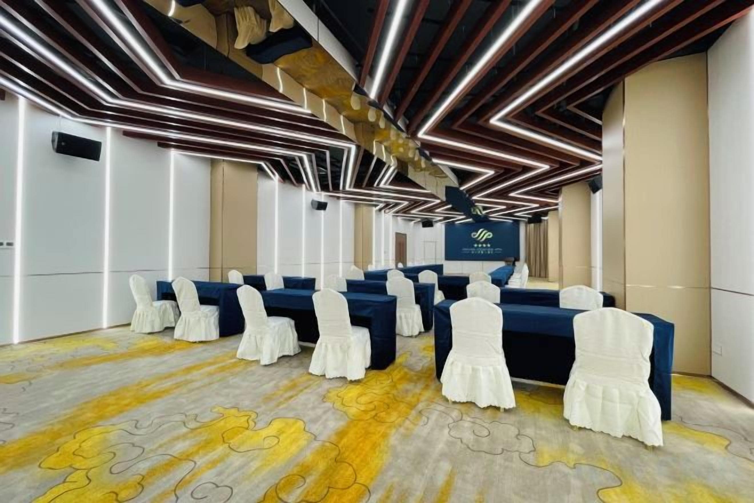 A conference room with a long table, chairs, and a podium.