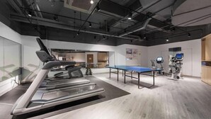 A modern fitness area with a treadmill, a ping pong table, and exercise equipment. - Kaisa Keyu Hotel (Shenzhen East Railway Station Buji Subway Station) (Shenzhen)