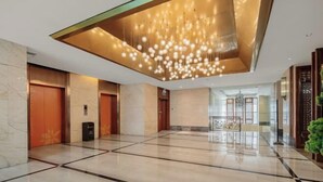 A spacious lobby with a modern chandelier, elevators, and a reception area. - Kaisa Keyu Hotel (Shenzhen East Railway Station Buji Subway Station) (Shenzhen)