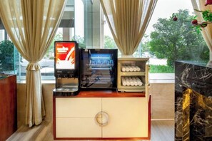 A hotel room with a minibar, a digital screen, and a marble fireplace. - Merlinhod Hotel (Yuncheng Airport, North Railway Station) (Yuncheng)