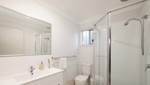 A modern bathroom with a glass-enclosed shower, a white sink, and a toilet. - 1 Bdr Apt w/ AC | Covered Parking | 431F1 (Rocklea)