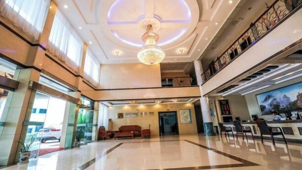 A spacious lobby with a chandelier, seating area, and a reception desk. - Jin Xiu Hotel (Yushan)