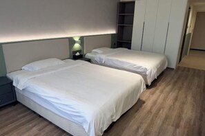 A room with two beds, a nightstand, a wall-mounted shelf, and a wardrobe. - Wenling Yunqi Garden Apartment (Wenling)