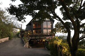 A two-story house with a balcony, surrounded by trees and a driveway. - Chingjing Top Cloud Resort (Nantou)