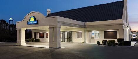 A Days Inn hotel with a modern design, featuring a prominent entrance and a well-lit facade.