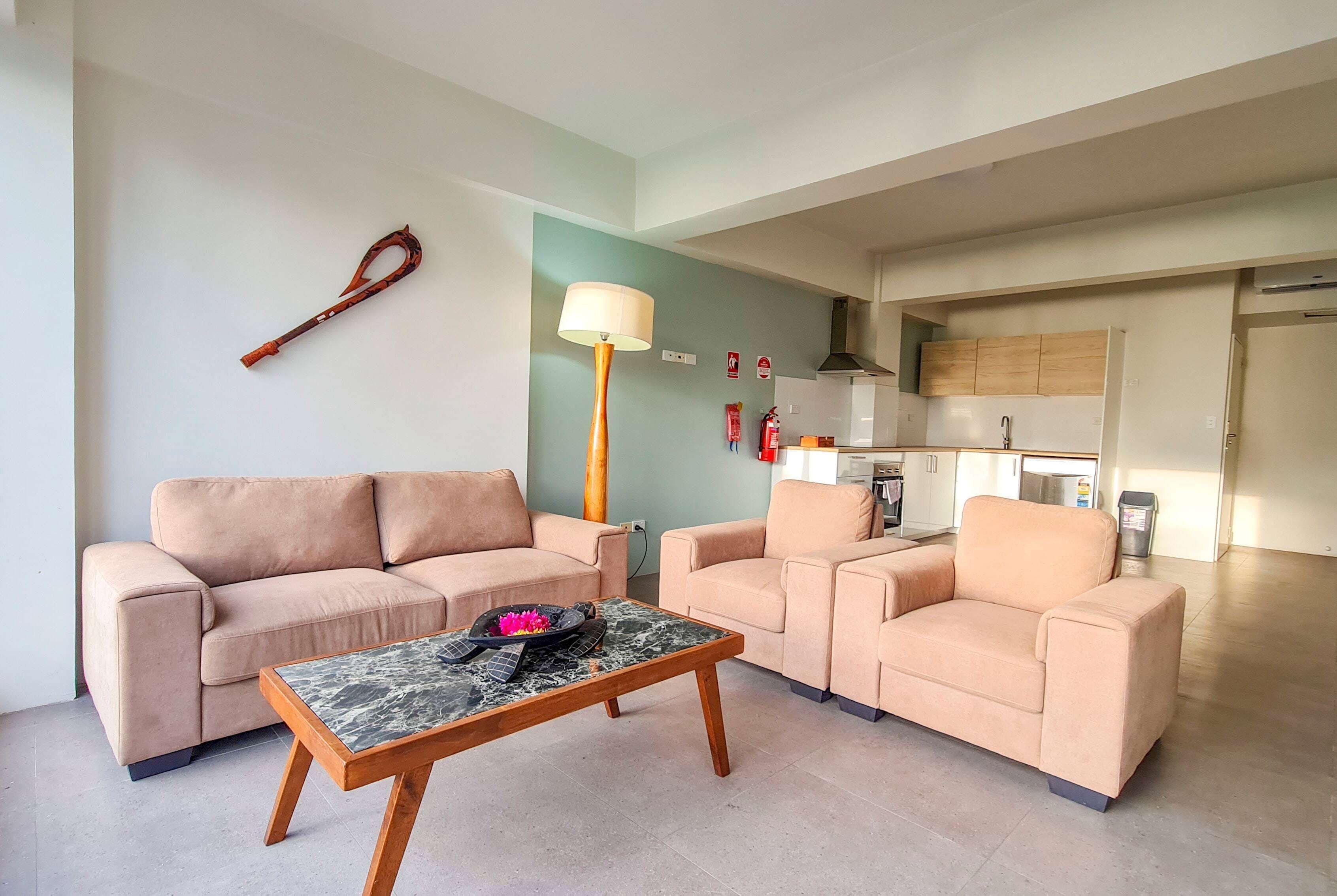 A living room with two sofas, a coffee table, and a lamp.