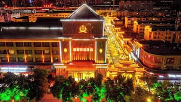 A brightly lit building with a prominent entrance and a large sign.