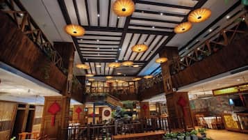 A spacious interior with high ceilings, wooden beams, and traditional lanterns.