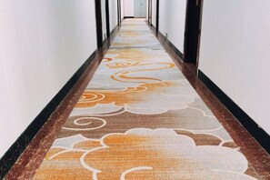 A hallway with patterned carpet and black-framed doors. - E·E Business Hotel (Guangzhou)