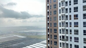 A high-rise building with multiple balconies and large windows. - Comfort Designed 2Br At Tokyo Riverside Pik 2 Apartment (Teluknaga)