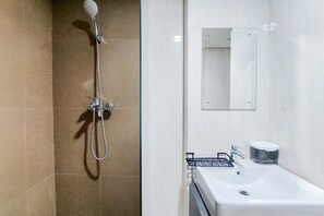 A bathroom with a shower, sink, and mirror. - Comfy And Minimalist 1Br At Tamansari Bintaro Mansion Apartment (South Tangerang)