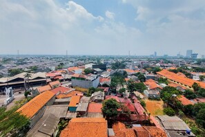 A cityscape with a variety of buildings, including residential and commercial structures. - Comfy And Minimalist 1Br At Tamansari Bintaro Mansion Apartment (South Tangerang)