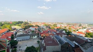 A residential area with houses, some with red roofs, and a clear sky. - Best Deal And Homey 1Br Without Living Room At The Alton Apartment (Semarang)