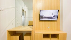 A wooden desk with a television mounted above it. - Best Deal And Homey 1Br Without Living Room At The Alton Apartment (Semarang)