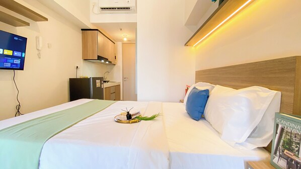 Relax in this stylish room with a comfortable bed, kitchenette, and TV.