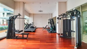 A spacious gym with treadmills, weight machines, and benches.