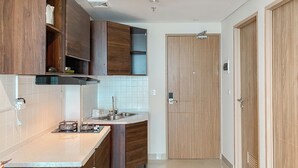 A modern kitchen with wooden cabinets, a stainless steel sink, and a gas stove.