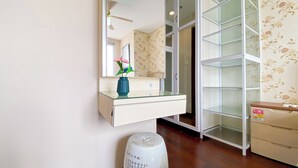 A bathroom with a glass shelf vanity, a mirror, and a toilet. - Modern Look 2Br At Lucky Tower Residence Apartment (Jakarta)