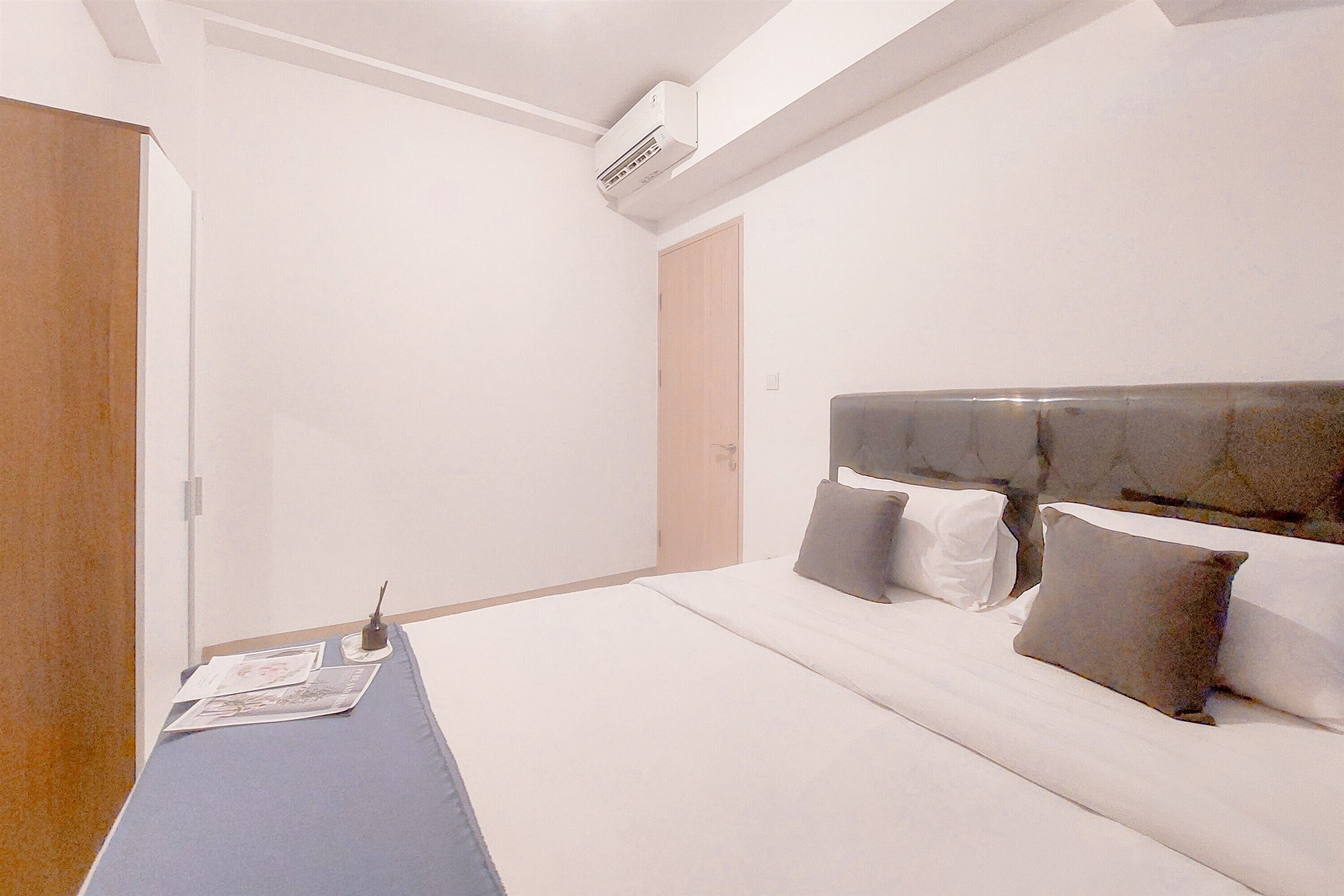 A hotel room with a bed, a desk, and a chair.