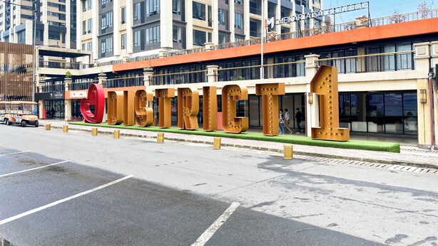 A modern building with large, metallic letters spelling "CITY" on the facade. - Good Deal And Comfortable 2Br Meikarta Apartment (Cikarang)