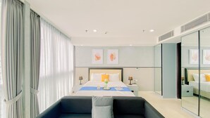 A modern hotel room with a large bed, a sofa, and a glass partition. - Good Deal And Elegant Studio Ciputra World 2 Apartment (Jakarta)