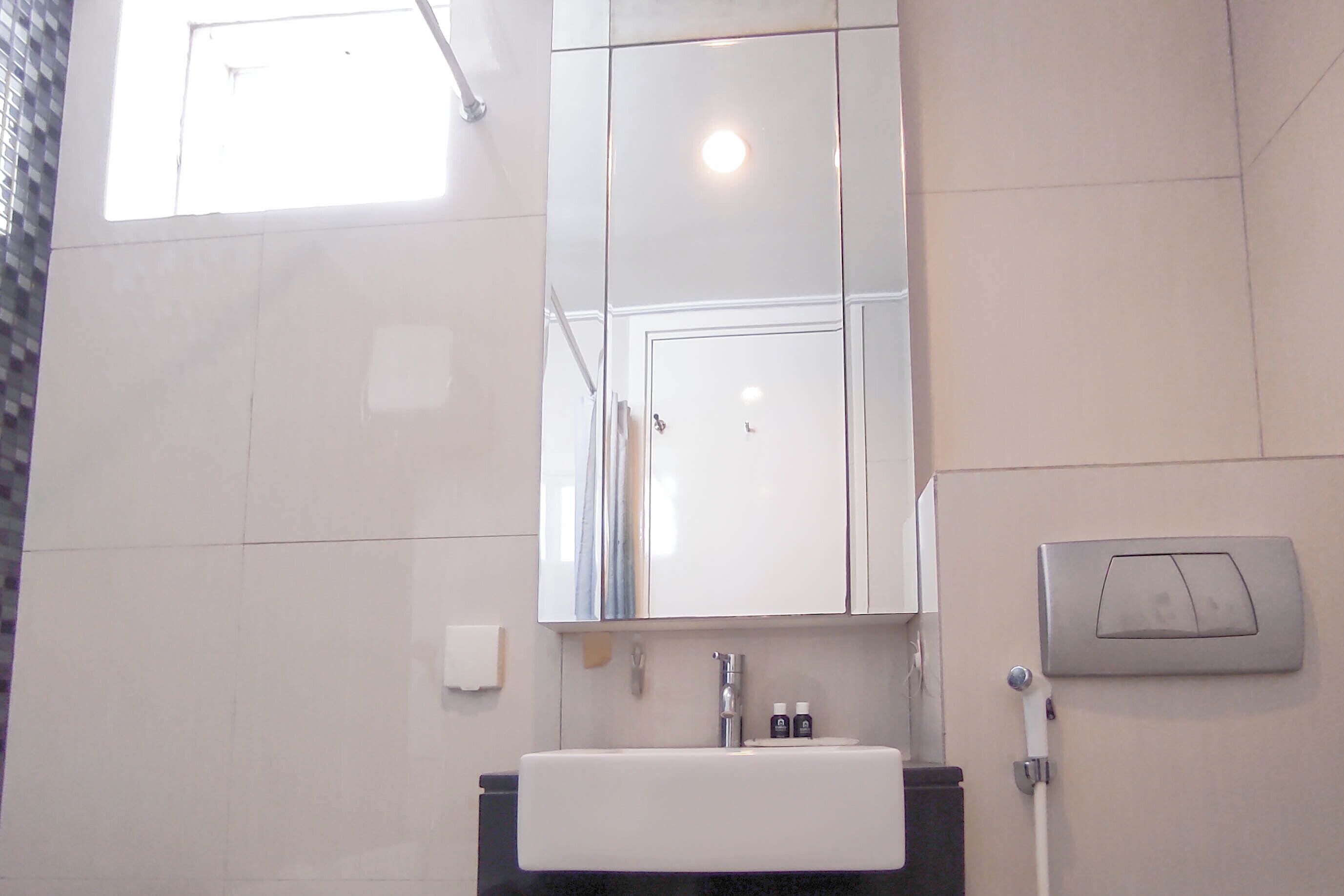 Ein Badezimmer mit Waschbecken, Spiegel und Handtuchhalter.
