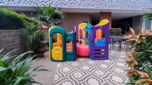 A children's play area with colorful play structures and a patterned floor. - Restful And Tidy Studio At Apartment Baileys (South Tangerang)