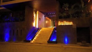 A hotel entrance with a staircase and a sign reading "La Brisa".