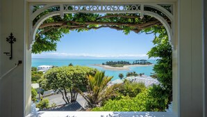 A balcony with a view of a beach and ocean.