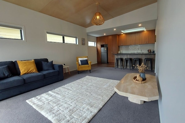 Living room with view to breakfast bar / kitchen. Couch folds out if needed.