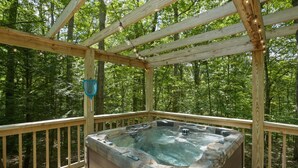 A hot tub on a wooden deck surrounded by a forest. - Hidden Ridge Cabin | Big Pine Retreat, Trails (Rockbridge)