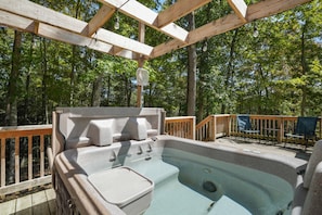 A hot tub under a wooden pergola with a wooden deck and chairs. - Ridge Point Cabin | Hocking Hills, Secluded (Rockbridge)