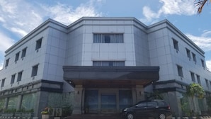 A modern building with a symmetrical facade, large windows, and a central entrance. - Nirmala Beach Hotel and Resort Biak (Biak)