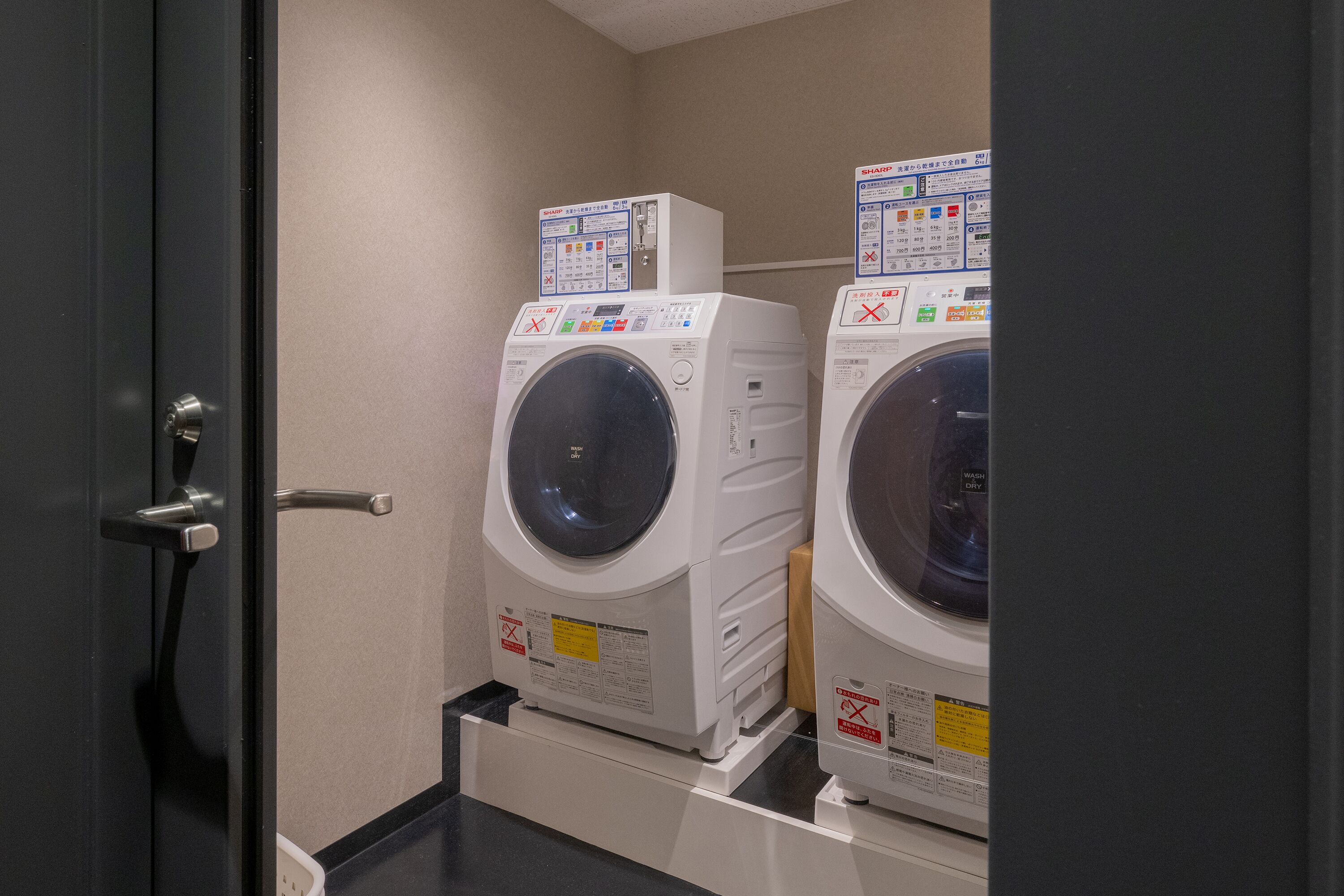 A laundry room with two stacked front-loading washing machines.