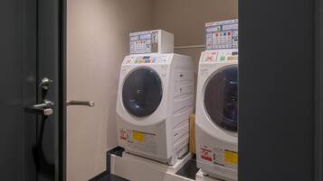 A laundry room with two stacked front-loading washing machines.