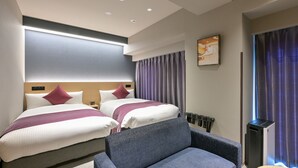 A hotel room with two beds, a sofa, a bedside table, a wall-mounted TV, and a window with curtains. - HOTEL R9 Premium Ichikawaekimae (Ichikawa)
