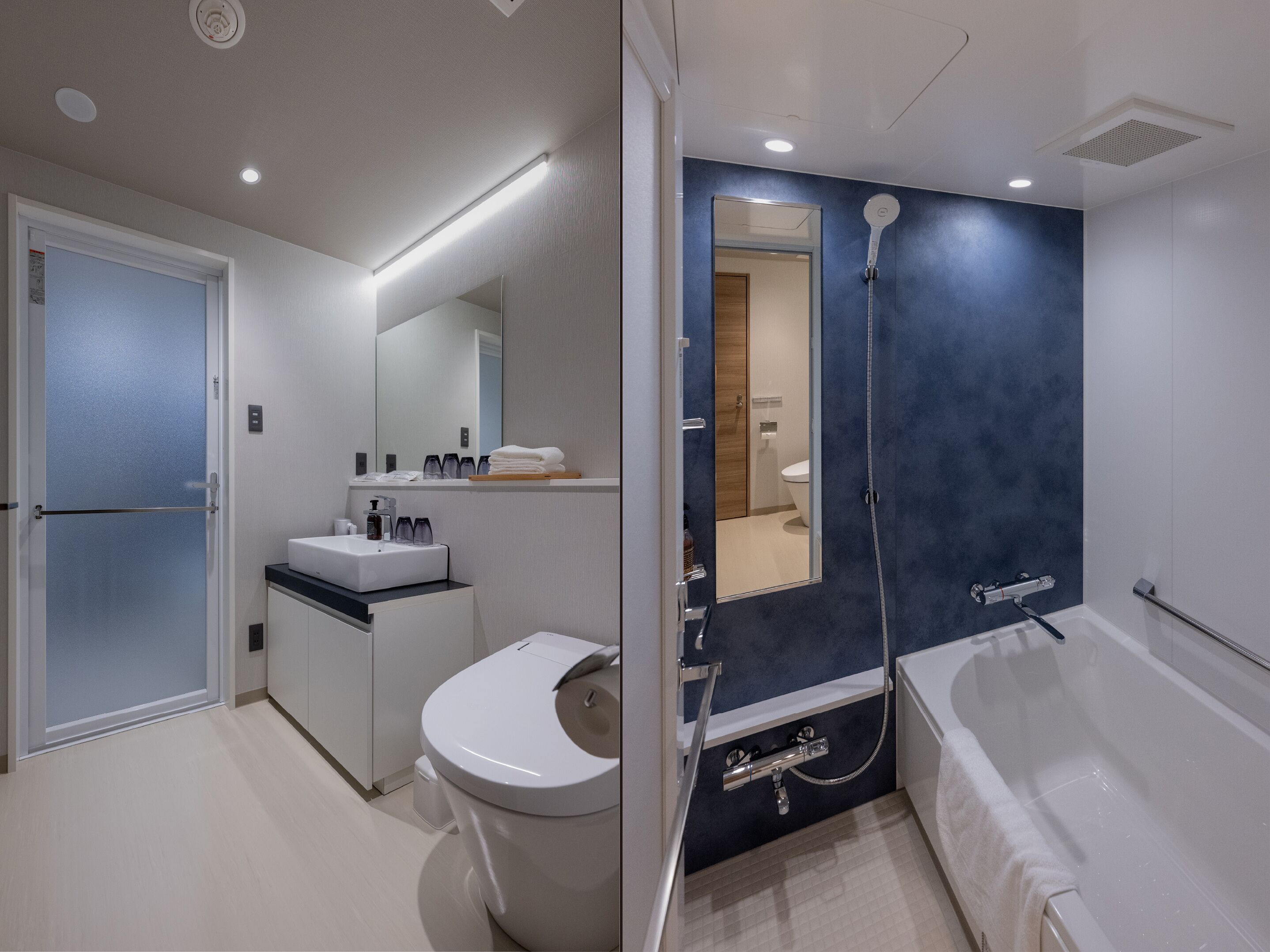 A modern bathroom with a toilet, sink, and bathtub.