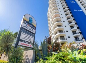 A sign for Alexander Holiday Apartments with amenities like indoor heated pool, spa, sauna, outdoor pool, and tropical BBQ area. - Alexander Apts - Ground Floor 2 Bedroom (Surfers Paradise)