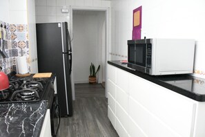 Fridge, microwave, stovetop, coffee/tea maker