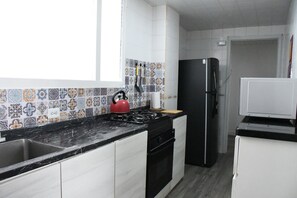 Fridge, microwave, stovetop, coffee/tea maker