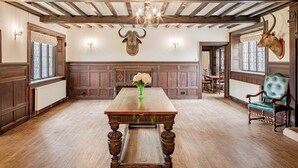 A dining room with a wooden table, a chandelier, and a deer head mounted on the wall. - Severn End - 15th Century Manor House (Worcester)