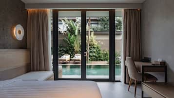 Deluxe Corner Pool Access | Minibar, in-room safe, desk, blackout curtains