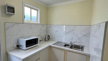 Fridge, oven, electric kettle, cookware/dishes/utensils
