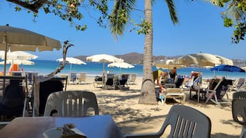 On the beach, sun-loungers, beach towels