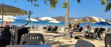 On the beach, sun loungers, beach towels