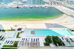 Enjoy a refreshing swim in our rooftop pool surrounded by lounge chairs and stunning marina views.