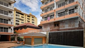 A swimming pool with 'New York' written on the edge, surrounded by multi-story buildings with balconies. - New Nordic Trend 3 (Pattaya)